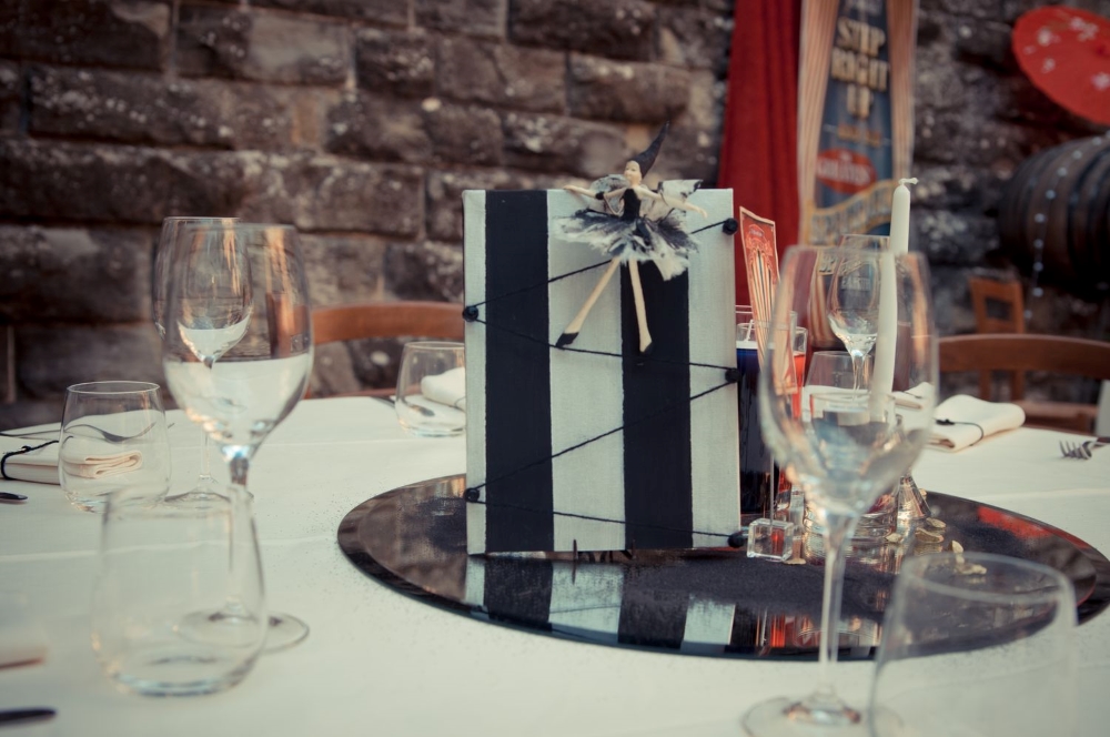 A black and white centerpiece with a ballerina doll, at a wedding in a castle