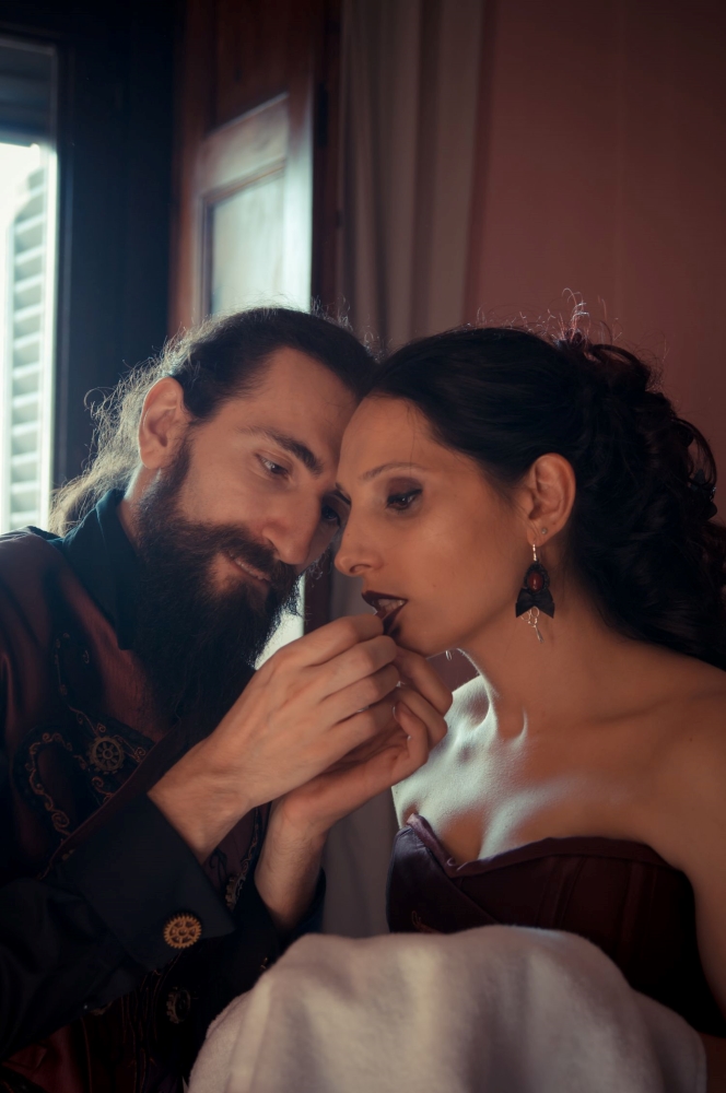 Gothic fantasy dressed bride and groom in a castle room for their wedding