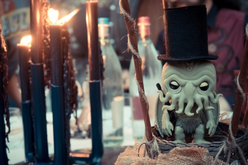 A table centerpiece with a cute version of H.P.Lovecraft's Chtulhu with black candles