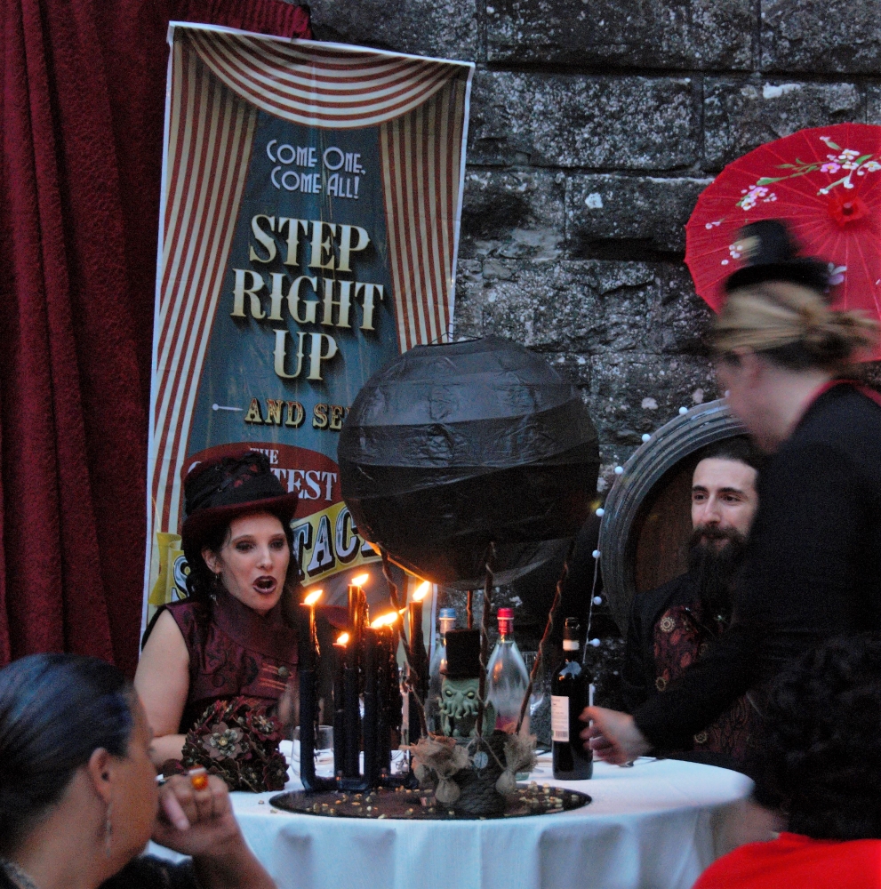 A Chtulhu centerpice being brought to the spouses' table, with a black hot air baloon and candles