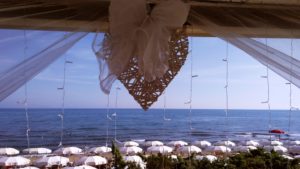 A beautiful view of the Seaside of Castiglione della Pescaia, Framed by tull, fairy lights and a heart, as you'd see on August 15th.