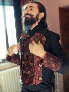 A groom in steampunk attire, satisfied by the results: the wedding will be wonderful!
